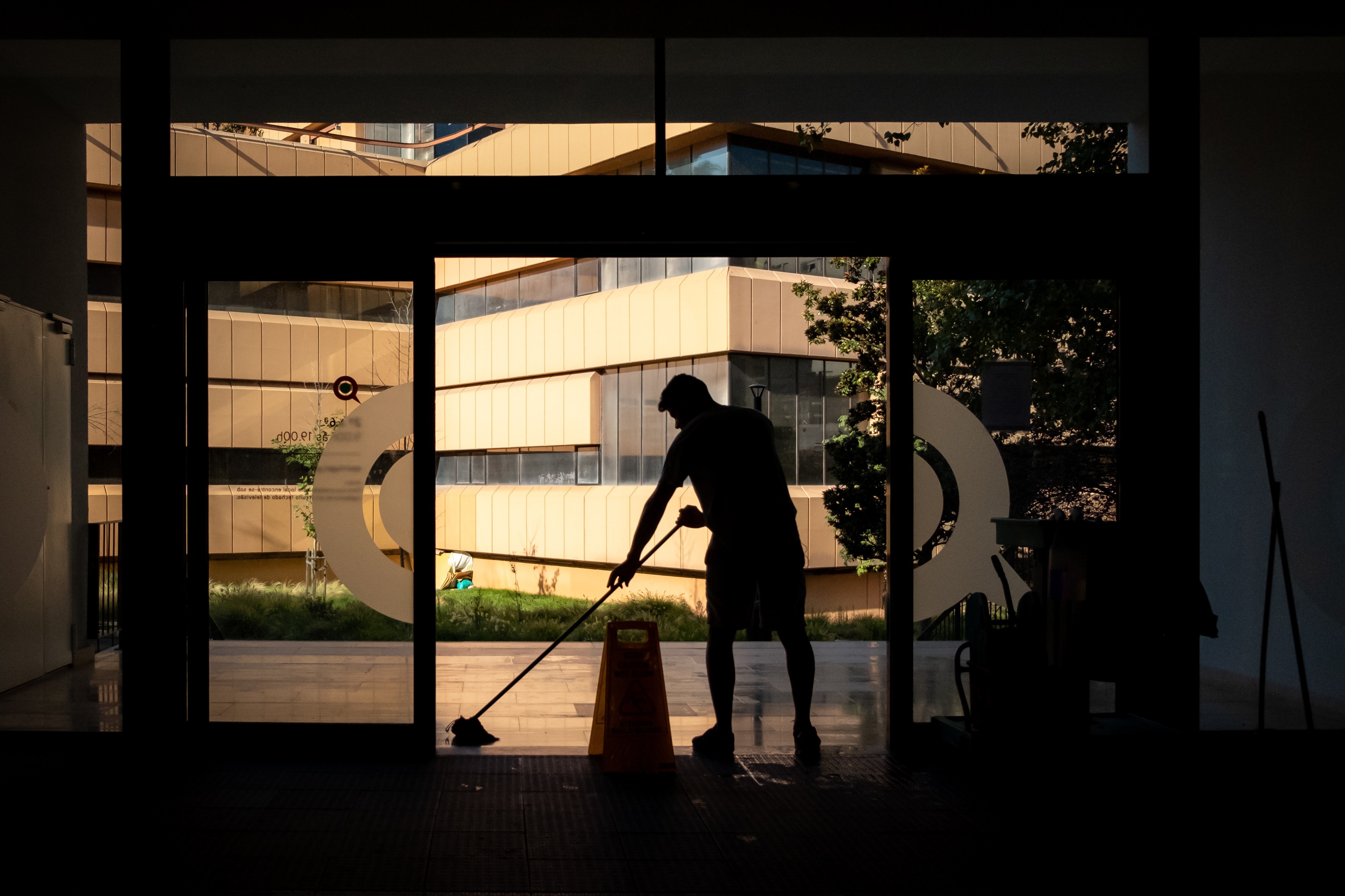 silhouette of person mopping